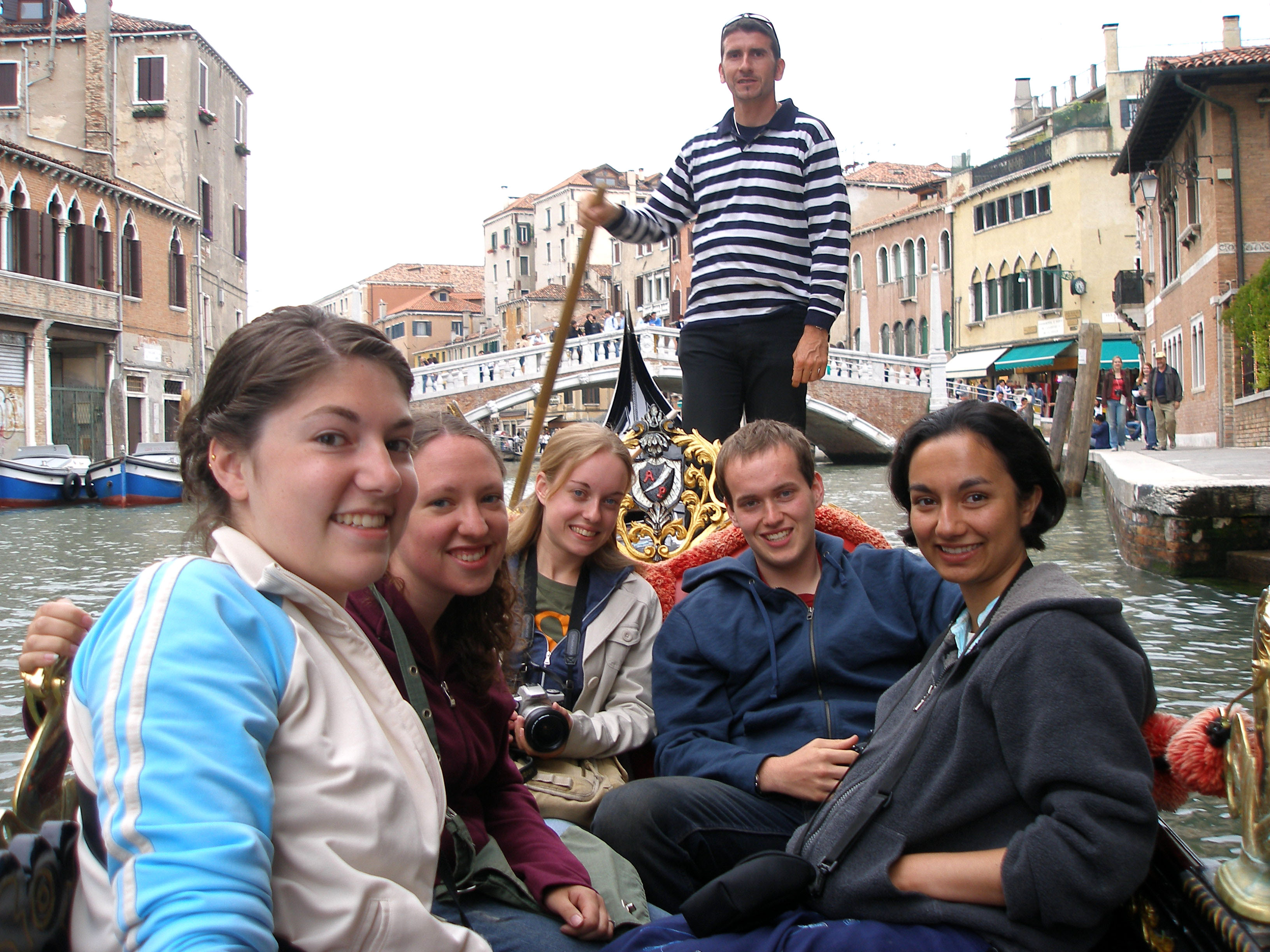 Students in a boat going along a river in Italy.