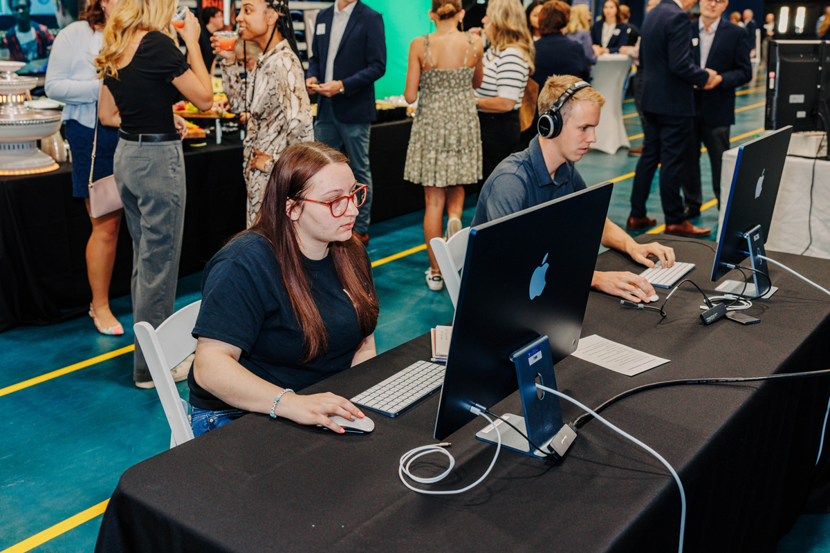 Students working on editing a video at Evening at the Arbor.