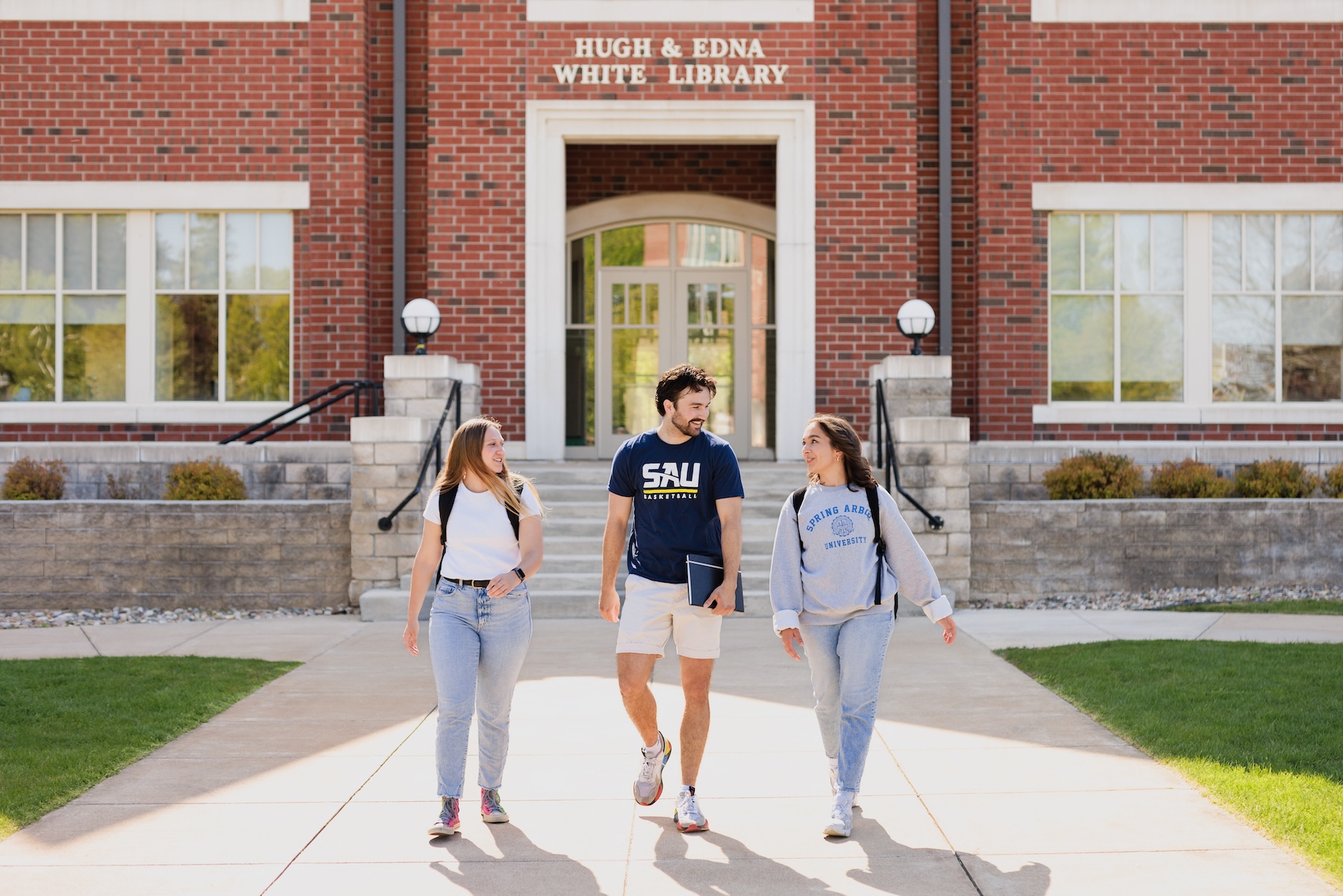 Students walking in front of the library