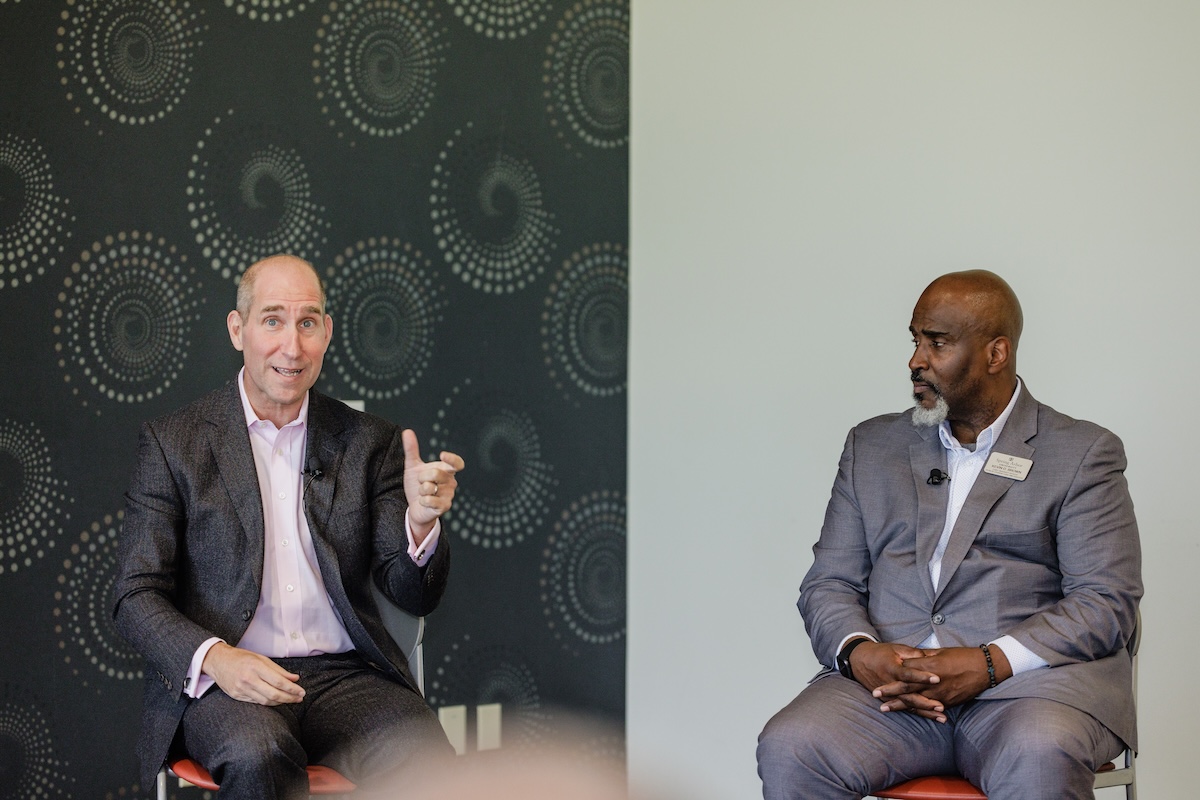 Simon Greer and Kevin Brown speaking at a luncheon