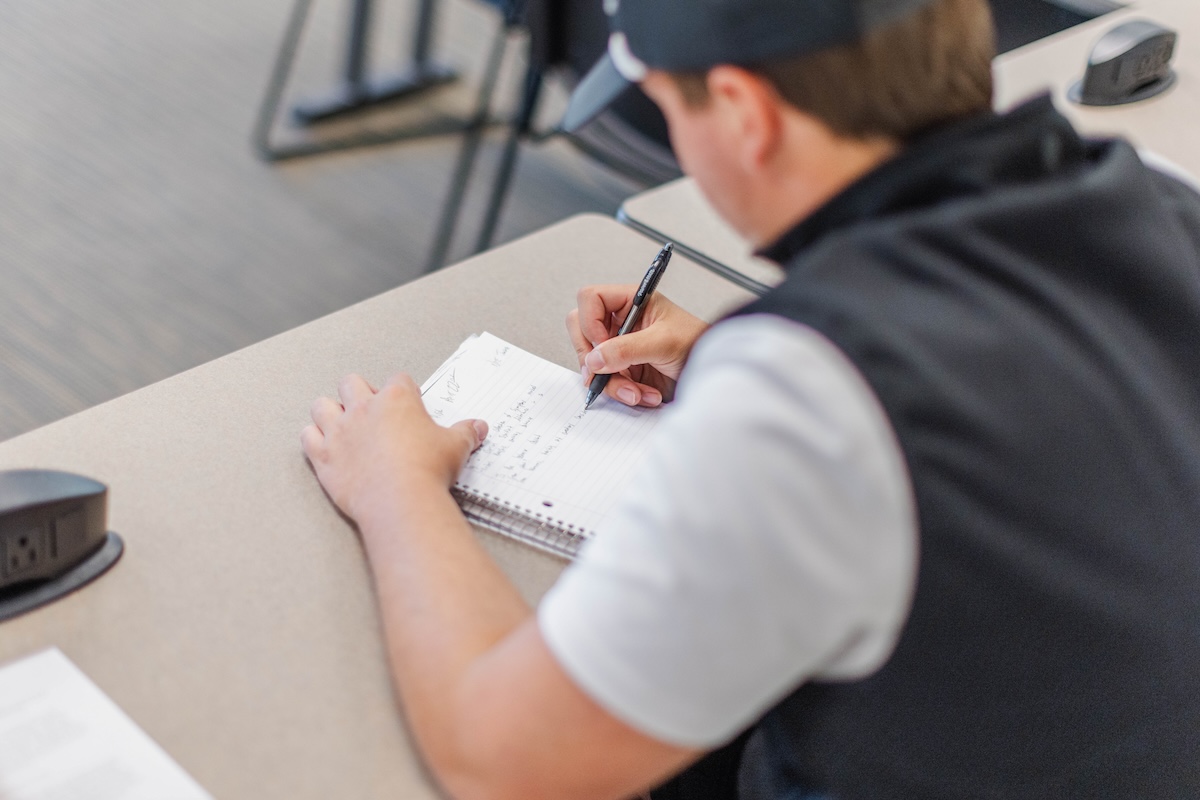Student taking notes in class
