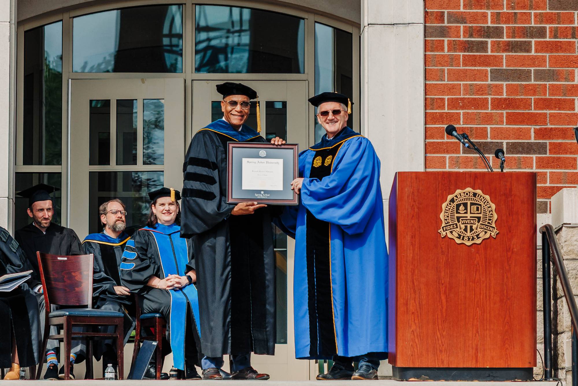 Ken Johnson receiving an honorary doctorate degree from SAU