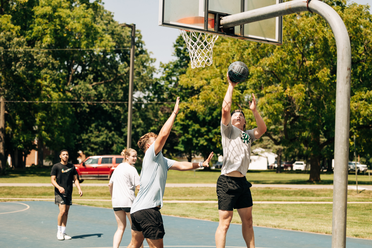 Students playing basketball outside.